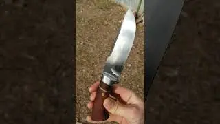 hand forged hunting knife made from a leaf spring with steel bolster
