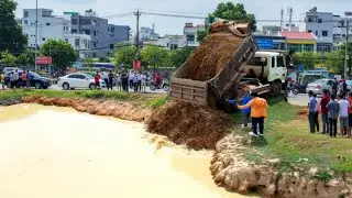 First Dump Truck Unloading Soil Into Water And Skill Bulldozer Pushing After
