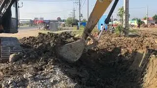 Excavator digging the road for drainage Work all day
