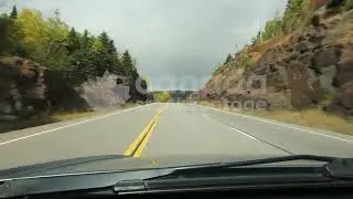 First person driving through rock cut stock video. Fall trees changing colours. Northern Ontario. HD
