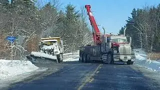 OTTAWA SNOW PLOW BEING TOWED OUT OF THE DITCH IN KANATA.