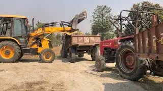 A JCB Backhoe Machine Loading Sand Onto Two Mahindra Tractors @DronePlanet