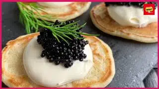 What is the tradition of Russian blini pancakes and their caviar pairings