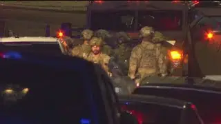 Person of interest in custody in shooting that killed postal worker also wanted in Atlanta murder