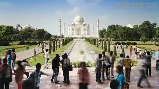 Timelapse of tourists having their photographs taken in front of the Taj Mahal