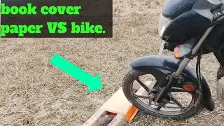 BOOK cover 📔 VS bike . Book cover paper 🗞️over bike . जिल के उपर बाइक चराई।
