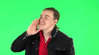 Guy screams calling someone on a green screen 4K footage
