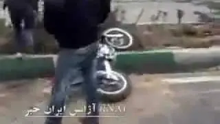 Basiji on red motorcycle falls and tries to run from protesters - Iran Tehran 27 Dec 2009 Ashura
