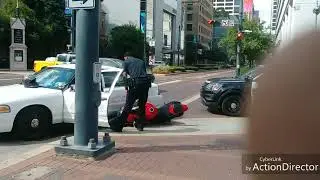 Cop / Motorcyclist incident down wrong way street corner.