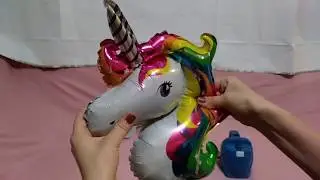 Failed attempt to pop the Unicorn foil balloons