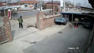 Man carefully parks a two-wheel tractor with utility trailer in Beijing, China