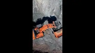 Vast open pit mine with Hitachi excavator and dump truck at work