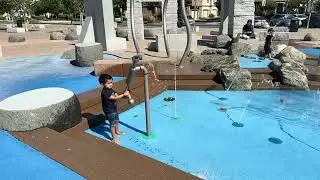 slow motion kid playing at splash park