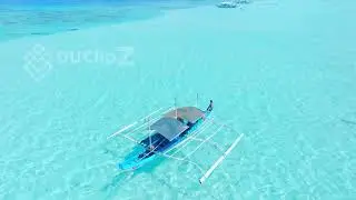 Boat Gliding Over Balabac&rsquo;s Emerald Waters from Above | 4k Video Stock Footage
