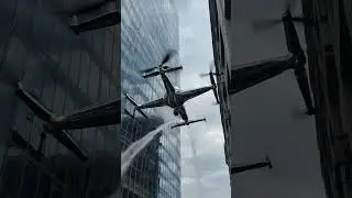 A drone cleaning skyscraper windows