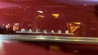 Classic Packard car on Rainbow Street, a colorful boulevard lined with shops, cafes, and street art.