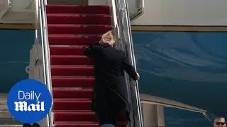 Trump's hair goes wild in wind as he boards Air Force One to WV