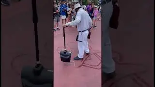 Walt Disney World Custodian paints character with water