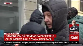 Zeci de oameni stau la cozi la cantina socială, înainte de Anul Nou