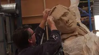 Man Lifting Cow: Long Life of Hard Work Inspired Sculpture