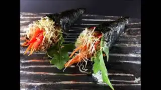 Seaweed hand rolls with rice, salad and sesame seeds