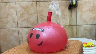 BLOWING UP WATER BALLOONS AND MAKING A DRAMA OF BALLOONS EXPLODING, UNTIL WATER SPRINGS