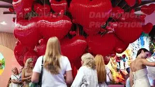 Moscow, Russia - August 17, 2025: Visitors enjoying a large art installation with numerous red