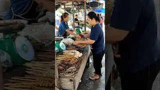 Raw Market Life: Two Women Selling Goods in a Muddy Traditional Market.@syarwani-ai