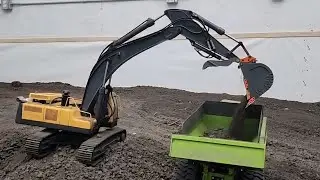 RC Volvo 360L excavator loading Volvo A40G haul truck