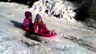 Emma and Rae sledding