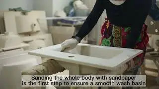 How the worker make the wash basin smooth and flat?