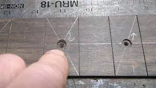 Drilling dot marker holes in a fret board.