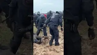 German riot police fall and sink in mud