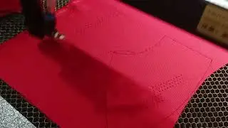 Laser Cutting Process For Golf Cap On Red Material 