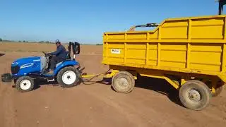 BOOMER 25  NEW HOLLAND  HALANDO  REMOLQUE  DE TOMATES  2.8 TONS DE PESO APROX.