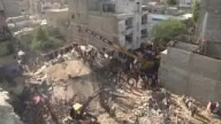 Rescue workers search wreckage of Karachi building