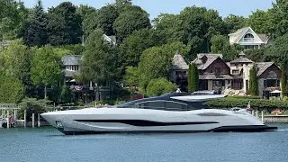 105 foot Mangusta yacht, named Delta Victor, cruising through Charlevoix Michigan harbor.
