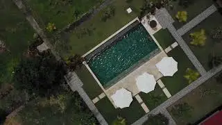 Drone Footage of Woman in Swimming Pool 
