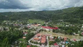 Small town is divided into two banks by means of river, which are connected by two bridges. Village