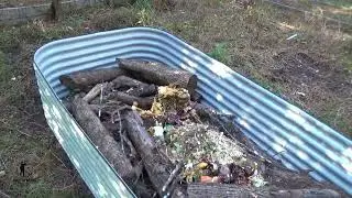 Starting a new raised bed garden from start to finish - Part 3 - Adding kitchen scraps, yard debris
