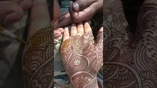Artist Kumar Chandan applying mehendi to his wife