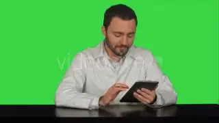 Smiling Doctor Using Tablet On a Green Screen - Stock Footage | VideoHive 14315089