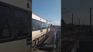 387116 and 387174 departing Knebworth as 700036 thunders past