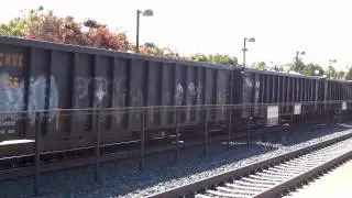 Freight train passing through the Mountain View CalTrain station in the afternoon