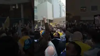 Leeds United fan on top of turnstiles at Elland Road. Going mental, promotion party. #leedsunited