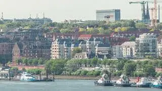 Aerial timelapse of Elbe riverside in Hamburg, Germany. Scenic view with boats near the pier
