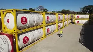 Houston - technician walking past stack of Eurotainer tank containers