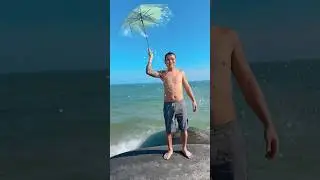 Dancing with a rainbow umbrella on the rocky beach 🏖️🐚🪸#shorts #beach #dance #rock #rainbow