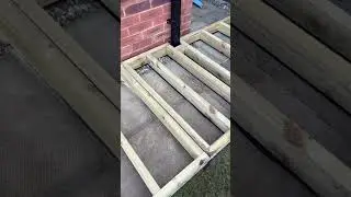 Fitting a decking frame around a closed rainwater pipe