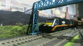 Model Railway: Grand Central HST 43484 leads 43465 pass on back line with a London to York Service